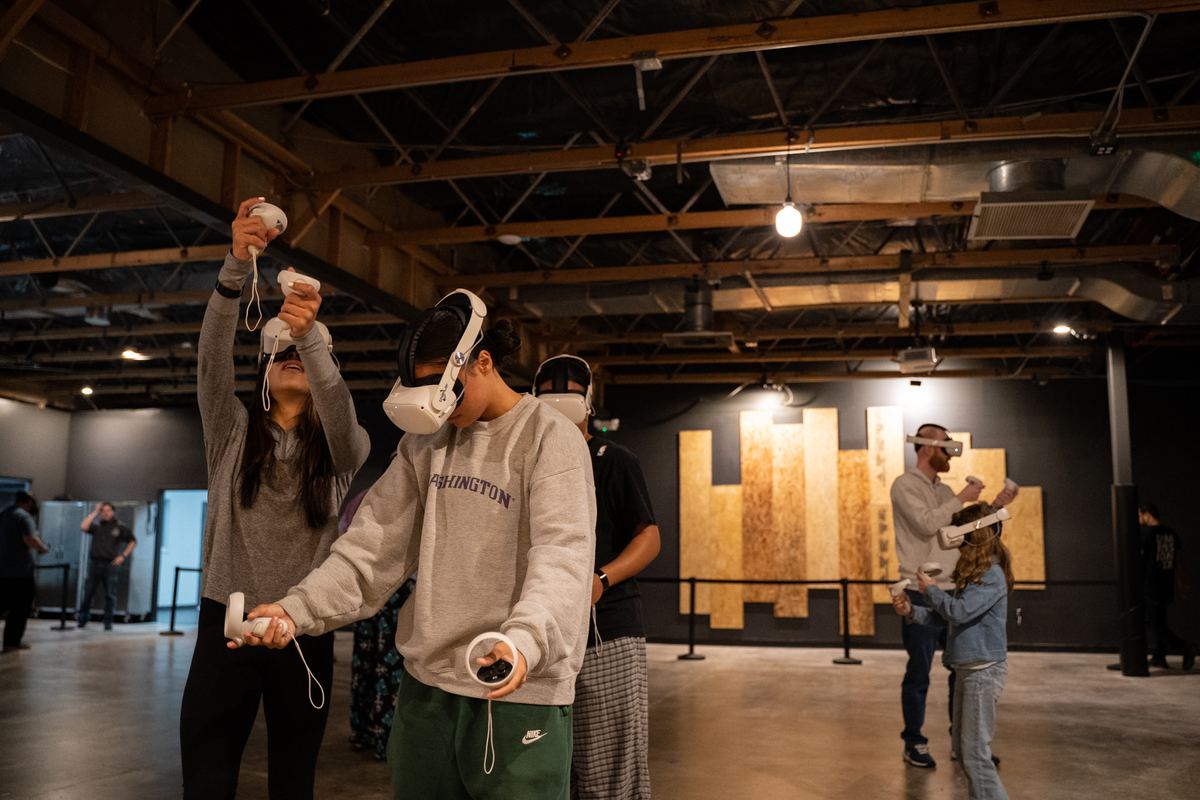 Players in headsets swing motion controllers in the Port Orchard arena.